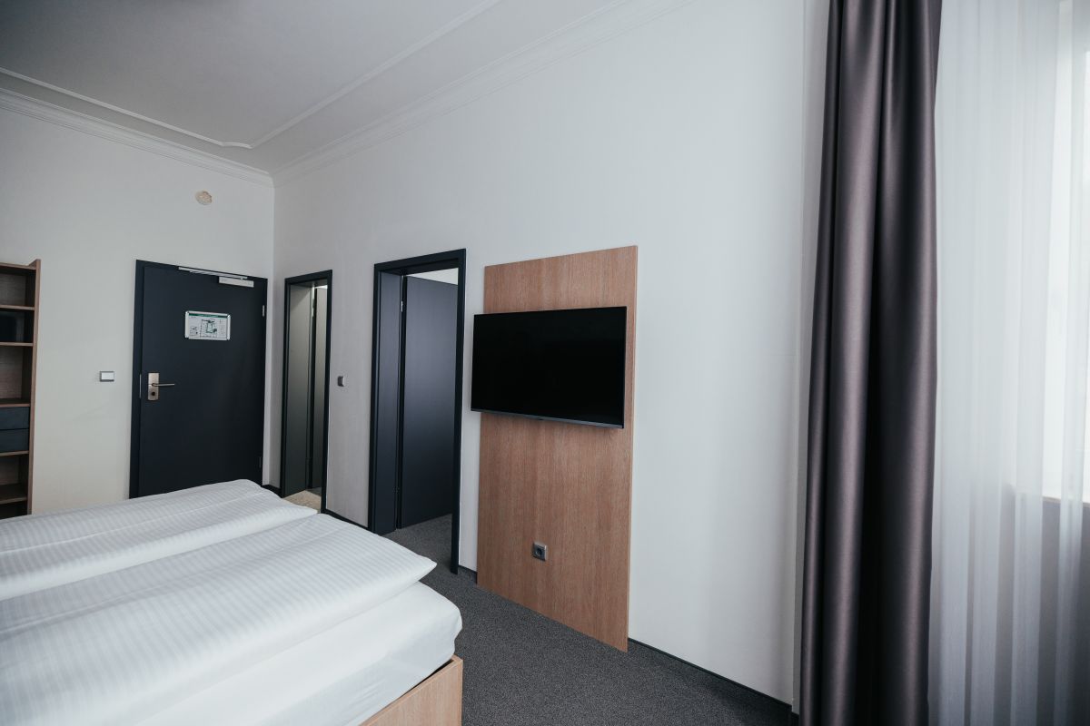 Einzelzimmer mit Bett und Smart-TV